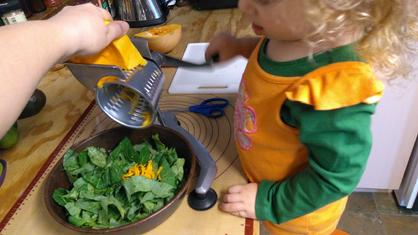 toddler helps to make salad